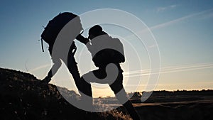 Teamwork two men help helping hand business travel silhouette concept. lifestyle two tourists lends a helping hand climb