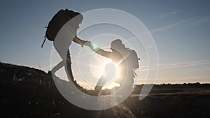 Teamwork two men help helping hand business travel silhouette concept. two tourists lifestyle lends a helping hand climb