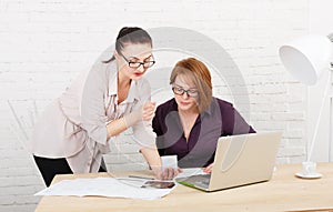 Teamwork. Women discuss project in office