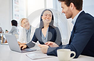 Teamwork, young asian businesswoman on a laptop and talking to colleagues in an office. Happy diverse businesspeople