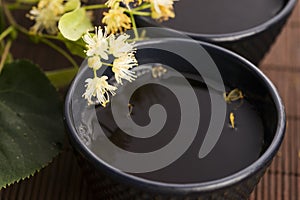 Teapot and cup with linden tea