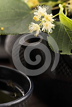 Teapot and cup with linden tea