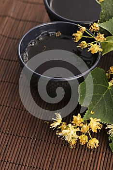 Teapot and cup with linden tea