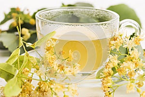 Teapot and cup with linden tea