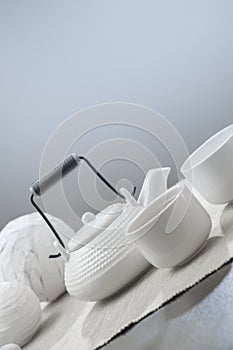 Teapot and cups on table