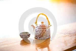 Teapot and cups on table