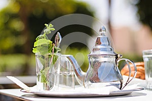 Teapot and glass with mint leaves, Morocco