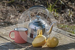 teapot with mug and pears on table