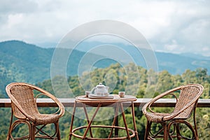 Teapot set on table in the morning with mountain view at countryside home or homestay. Vacation, travel and trip concept