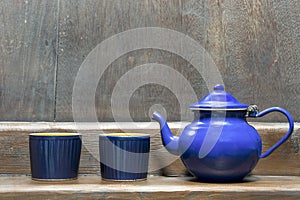 Teapot with two blue cups