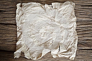 Tear crumpled brown paper on wooden