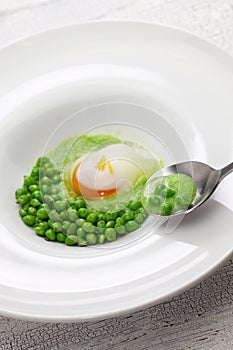 Tear peas with poached egg, spanish basque cuisine photo