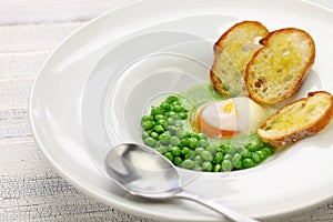 Tear peas with poached egg, spanish basque cuisine photo