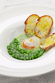 Tear peas with poached egg, spanish basque cuisine photo