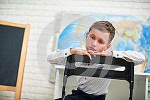 Tearful, sad, child, tired of school. He can`t do his own homework photo