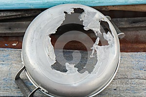 Tearing and broken steel kitchen pot