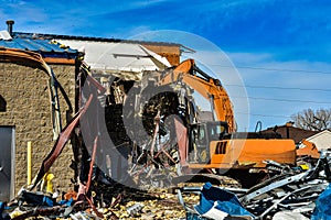 Tearing down older commercial building to make way for new business.