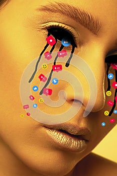 Tears illustrated of social media activity signs on female face in neon light. Real life versus online lifestyle