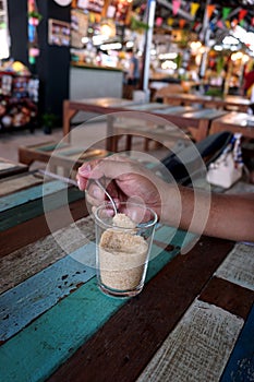 Teaspoon of sugar and hand man