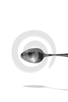 Teaspoon top view with reflection isolated on white background