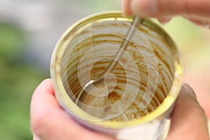 A teaspoon is used to get the last caramel out of a can while making a banoffee pie