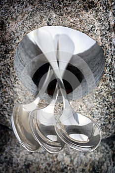 Teaspoons balancing on stone