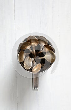 Teaspoons in a metal cup