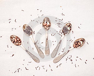 Teaspoons, a scattering of tea and coffee beans