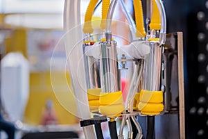 Teat cups of automated cow milking suction machine at exhibition: close up