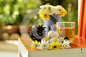 Teatime with Chinese pastry and tea and flower on a orange chair