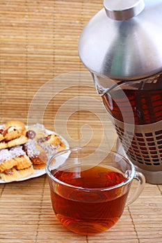 Teatime: cup of tea, teapot and cookies