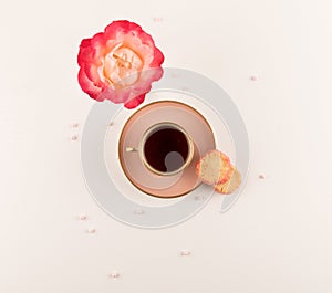 Teatime, Pink cup of tea, Pink rose and biscuits  Cookies on white table. top view. Copy space photo
