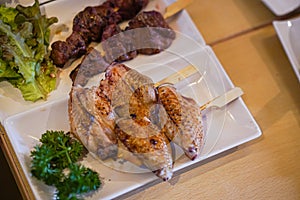 TEBASAKI traditional grilled skewer of chicken wings photo