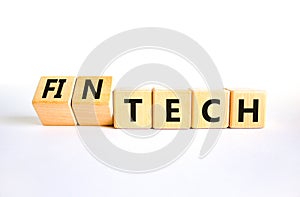 Tech or fintech symbol. Concept word Tech and Fintech on wooden cubes. Beautiful white table white background. Business and tech