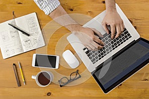 Tech Hipster Working at Wooden Desk on Laptop