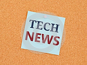 TECH NEWS written on sticky note paper over a kork board. Business concept for newly received or noteworthy information about