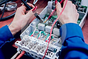 Tech tests electronic equipment in service centre