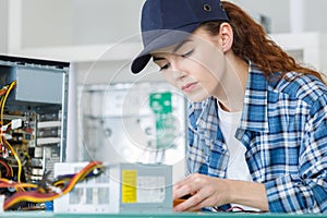 Tech tests electronic equipment in service centre