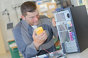 Techie technician using voltmeter photo