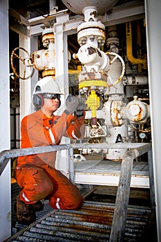 Techincian operator during close or open valve in process oil and gas platform offshore industrail