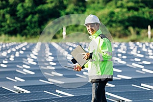 Technical expert in solar energy photovoltaic panels, remote control performs routine actions for system monitoring using clean,