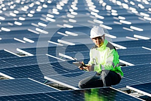 Technical expert in solar energy photovoltaic panels, remote control performs routine actions for system monitoring using clean,