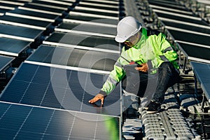 Technical expert in solar energy photovoltaic panels, remote control performs routine actions for system monitoring using clean,