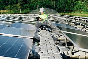 Technical expert in solar energy photovoltaic panels, remote control performs routine actions for system monitoring using clean,