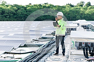 Technical expert in solar energy photovoltaic panels, remote control performs routine actions for system monitoring using clean,