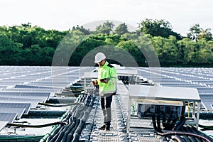 Technical expert in solar energy photovoltaic panels, remote control performs routine actions for system monitoring using clean,