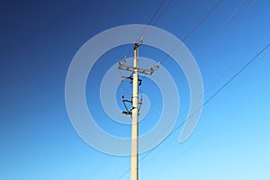 Technical picture of a three-cable medium voltage line. Tutorial. School material. Object on the background of a blue sky with clo