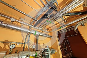 Technical pipes for sewerage in the basement of a building with pressure gauges. canalization system