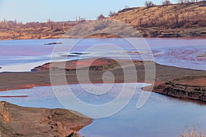 Technical settler of industrial water of mining industry in Kryvyi Rih, Ukraine. Red water polluted with iron ore waste