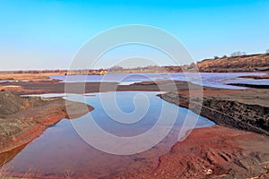 Technical settler of industrial water of mining industry in Kryvyi Rih, Ukraine. Red water polluted with iron ore waste photo